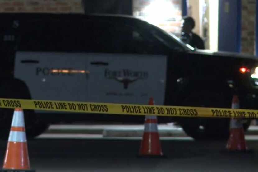 Crime tape marks the spot near where three people were injured in a drive-by shooting Monday...