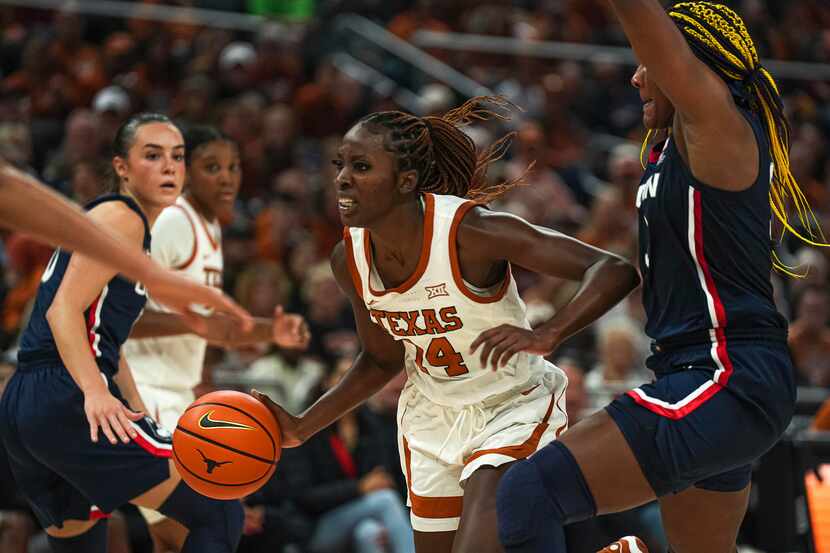 Texas forward Amina Muhammad (14) pushes past UConn forward Aaliyah Edwards, right, during...