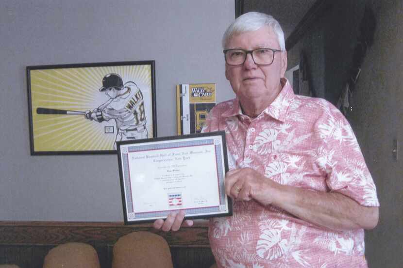 Tom holding a certificate from the National Baseball Hall of Fame, acknowledging his Texas...