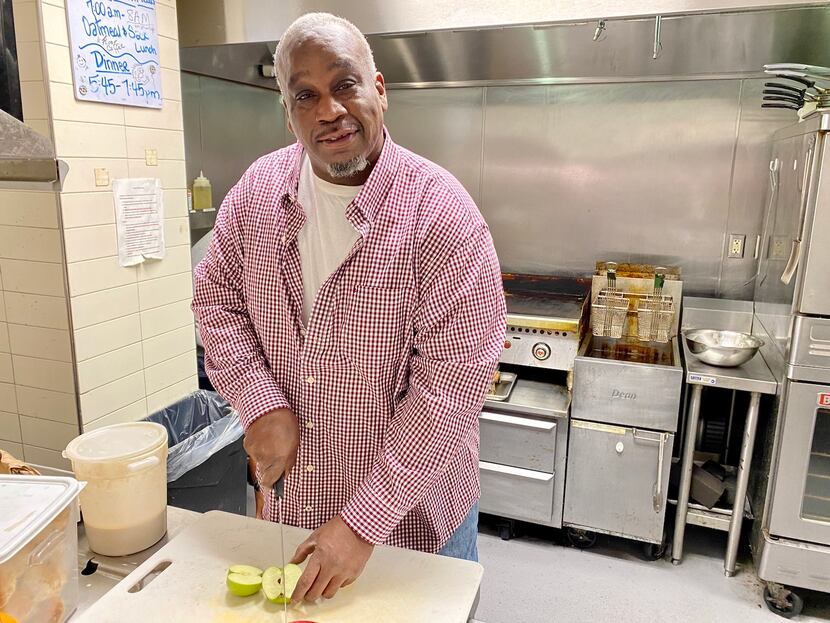 Cook JC Anderson of The Dallas 24 Hour Club's Hubcap Cafe slices an apple in the kitchen.