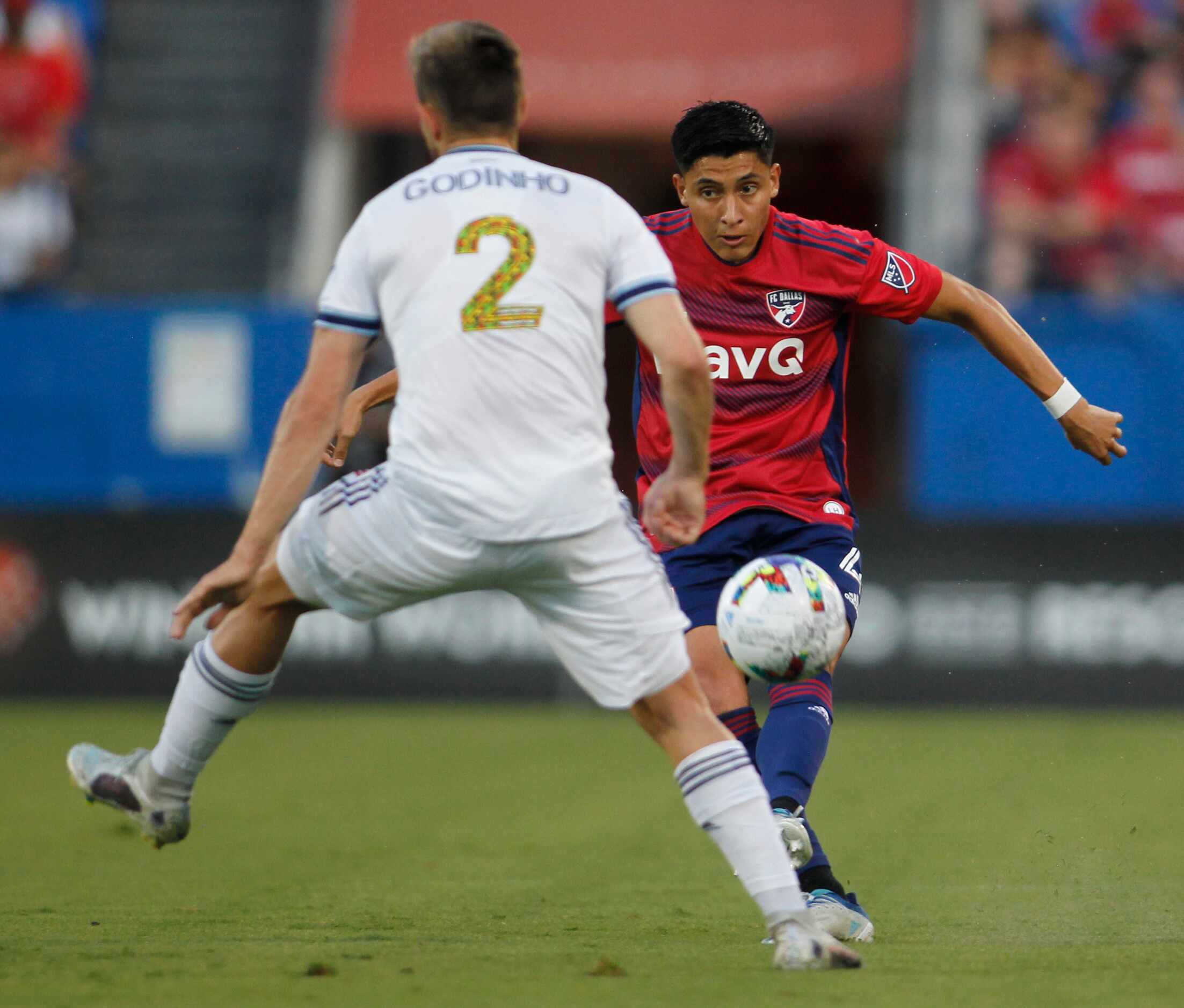 FC Dallas defender Marco Farfan (4) eyes the defense of Vancouver's 
Marcus Godinho (2) as...