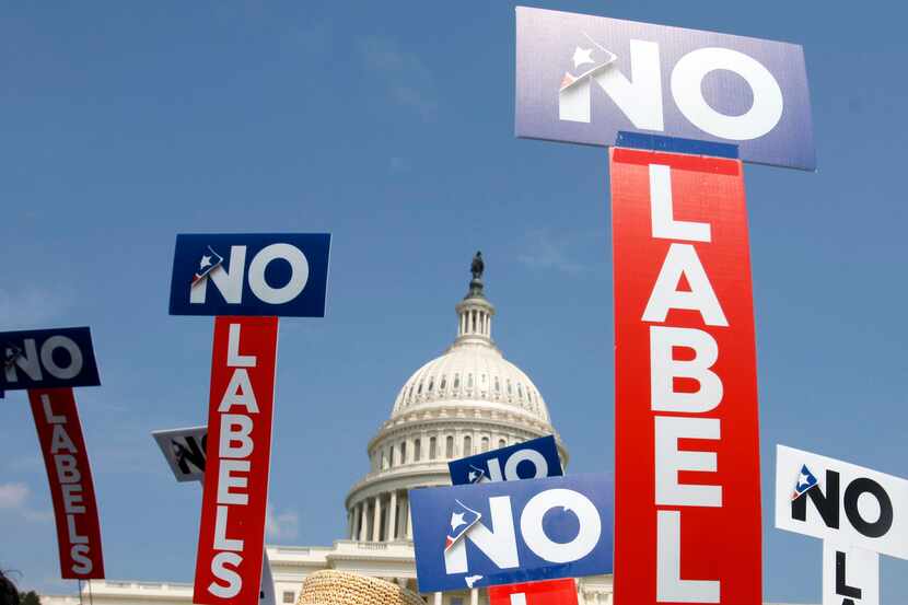 People with the group No Labels hold signs during a rally on Capitol Hill in Washington,...