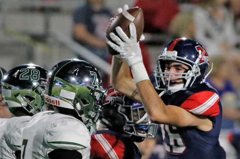 McKinney Boyd defender Matteo Bianchi, left, celebrates his first-quarter fumble recovery...