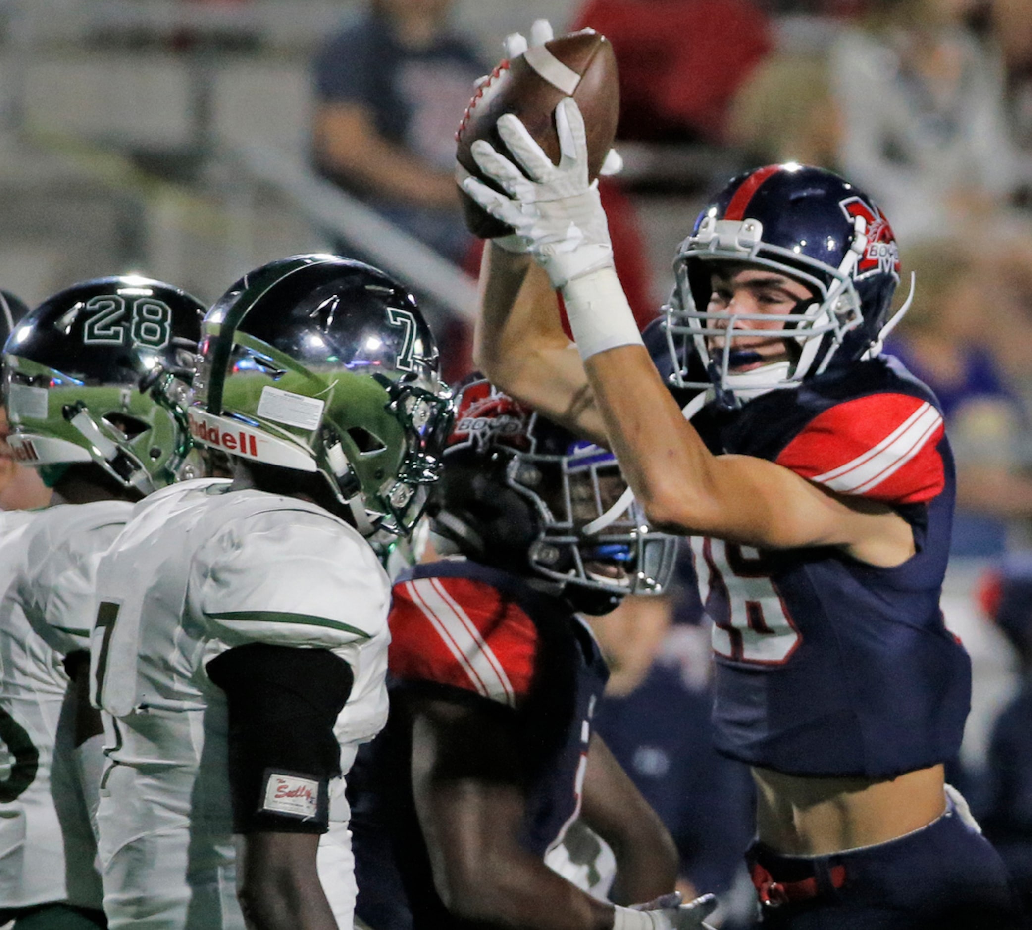 McKinney Boyd defender Matteo Bianchi, left, celebrates his first-quarter fumble recovery...