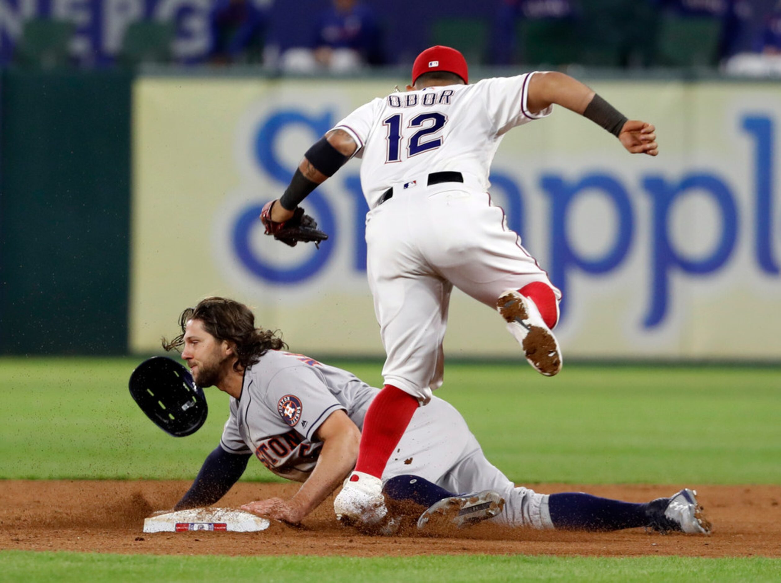 Texas Rangers second baseman Rougned Odor (12) avoids contact with Houston Astros' Jake...