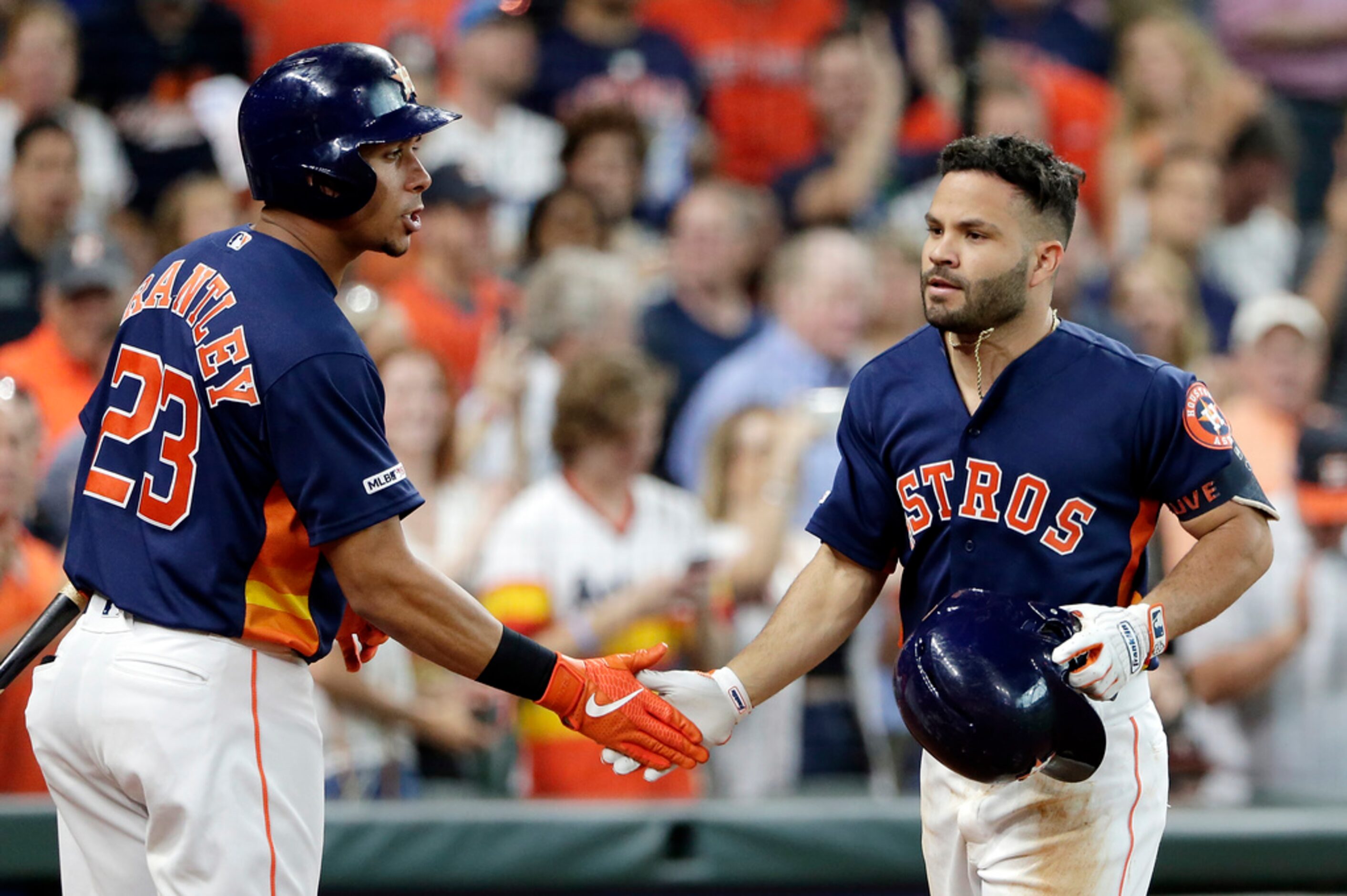 Houston Astros Michael Brantley, left, celebrates the home run by Jose Altuve, right, during...