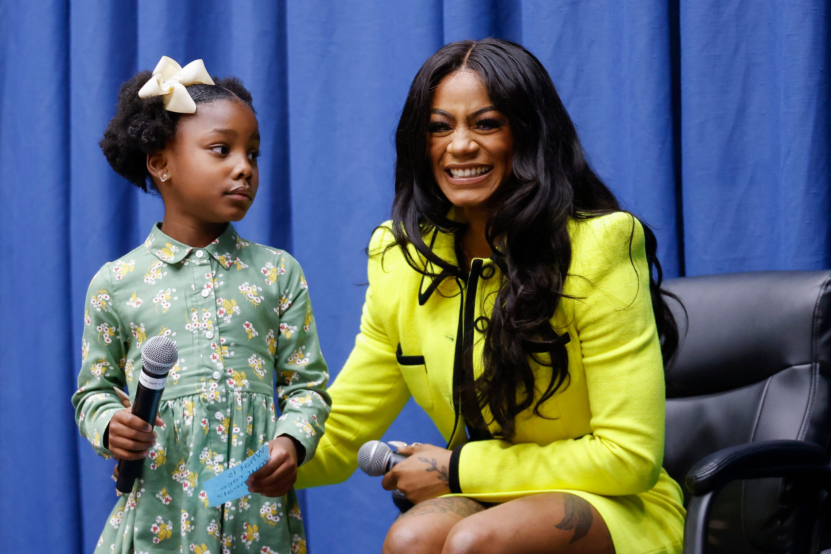 Brooklyn Cross, 10, (left), looks towards 100 meters world champion Sha'Carri Richardson, a...