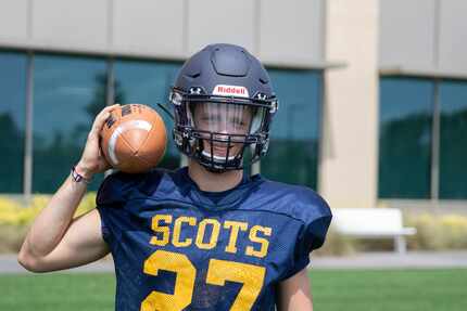 Highland Park High School football player Walker Cobb in his jersey, holding a football.