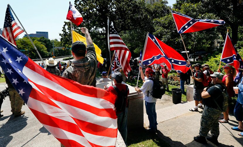 Flag-carrying protesters joined the This Is Texas Freedom Force protest over removal of the...