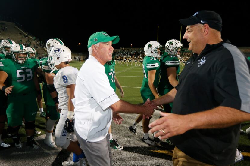 Southlake Carroll coach Hal Wasson greets Hebron coach Brian Brazil after Southlake defeated...