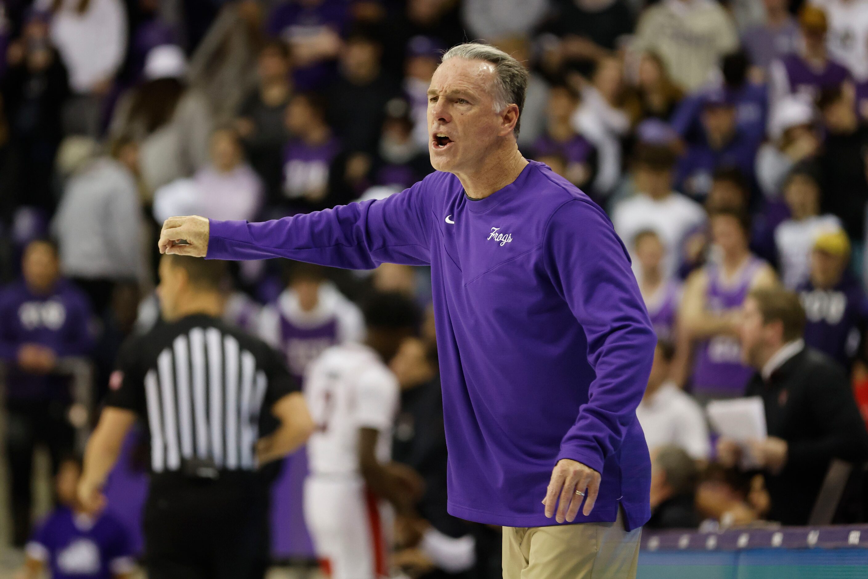 TCU head coach Jamie Dixon directs his team against Texas Tech during the first half of...