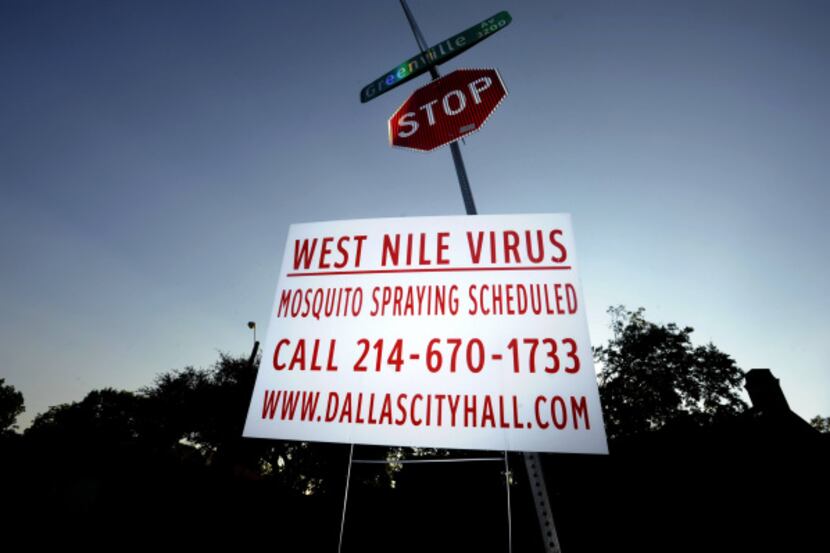 A sign at Monticello and Greenville avenues in Dallas announces scheduled mosquito spraying.