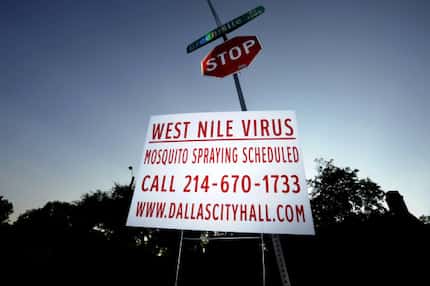 A sign at Monticello and Greenville avenues in Dallas announces scheduled mosquito spraying.