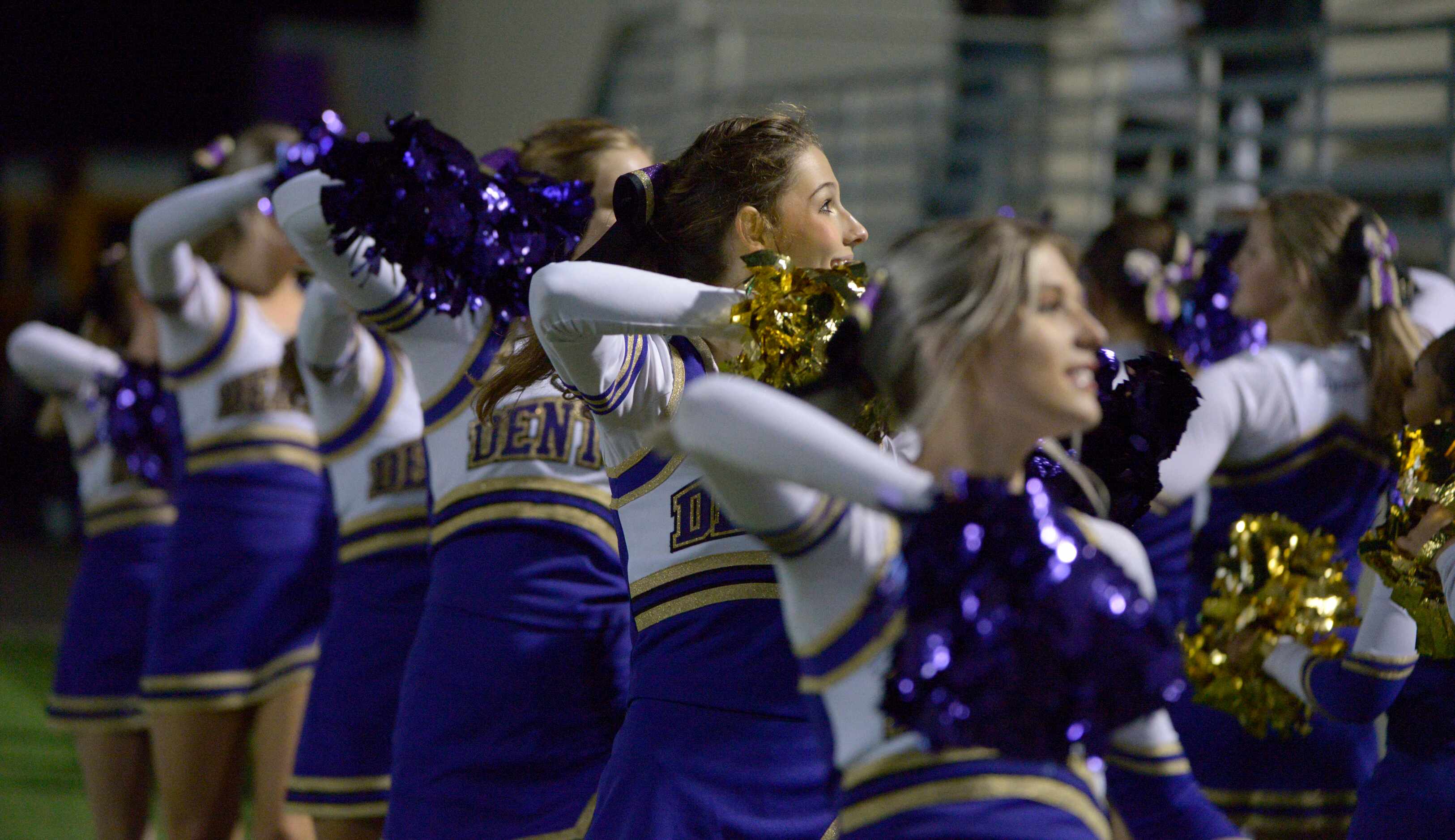 Denton cheerleaders perform in the first quarter of a high school football game between...