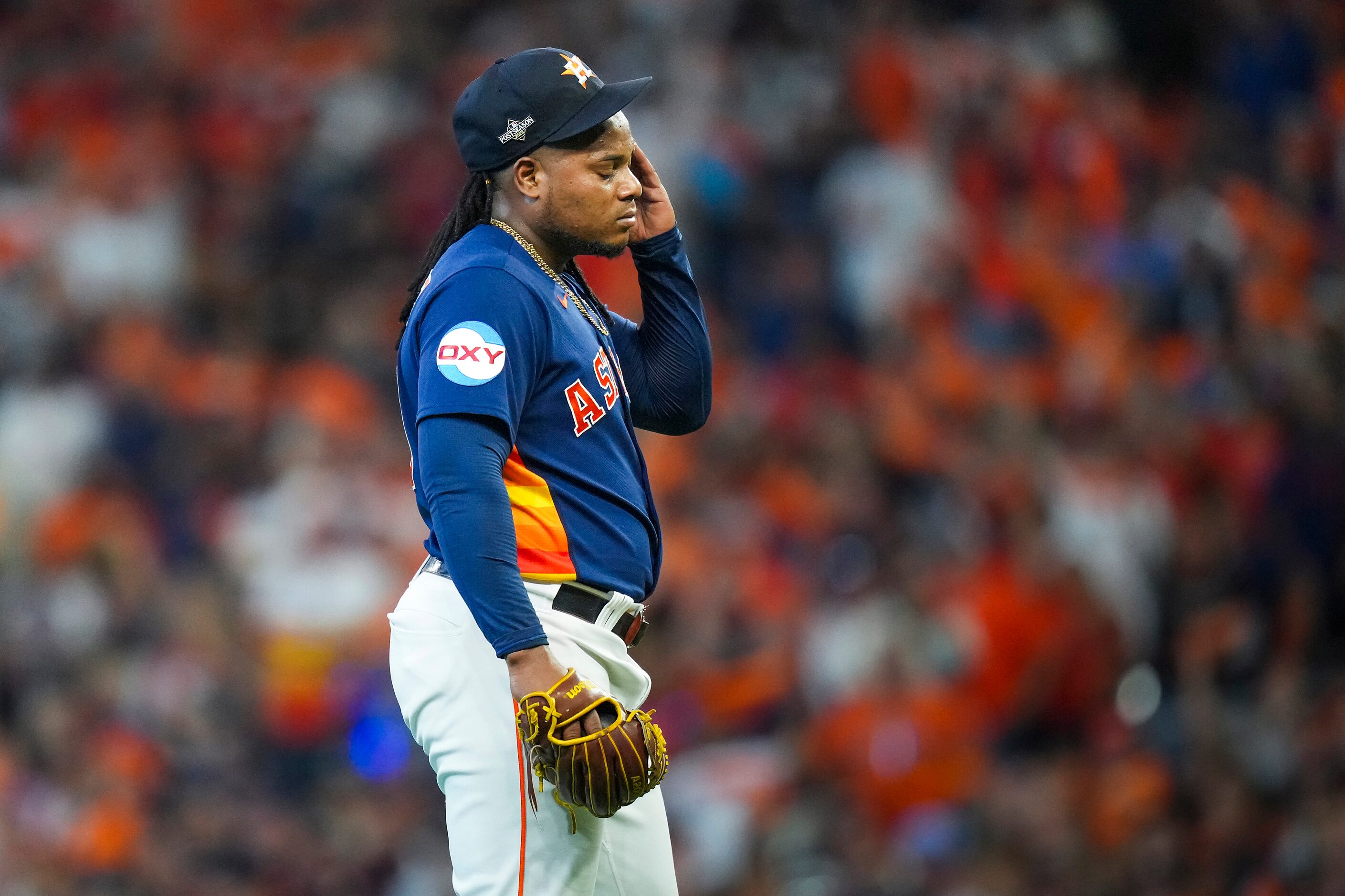 Houston Astros starting pitcher Framber Valdez reacts after giving up a run on his own error...