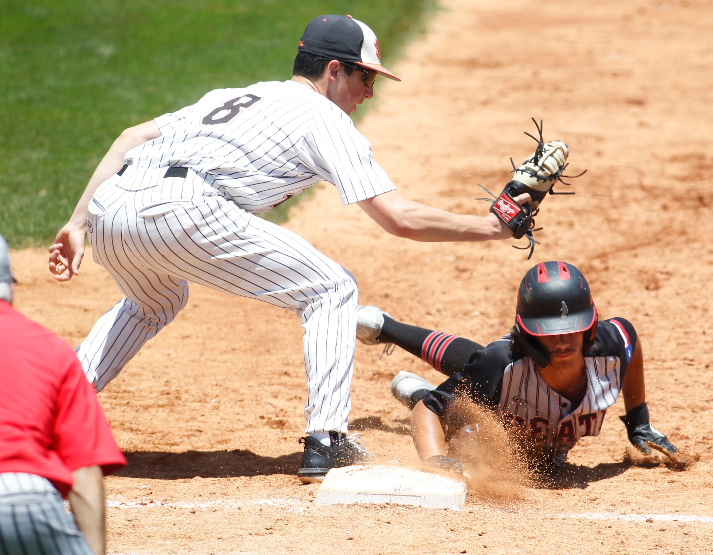 Rockwall baserunner Alex Stowers (2) dives back safely into first base as Rockwall first...