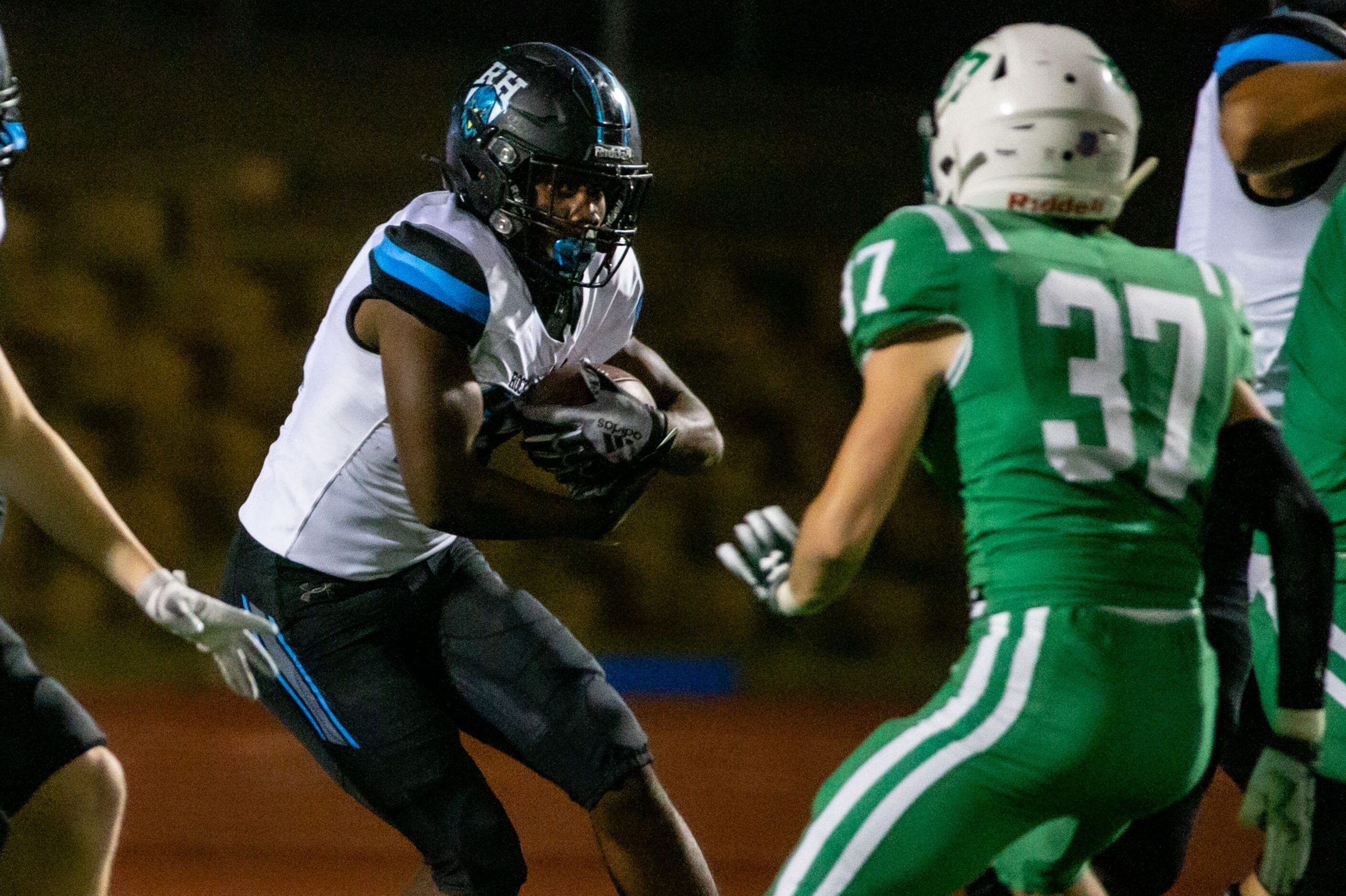 Rock Hill running back Donovan Shannon (22, left) tries to evade Dallas Lake linebacker...