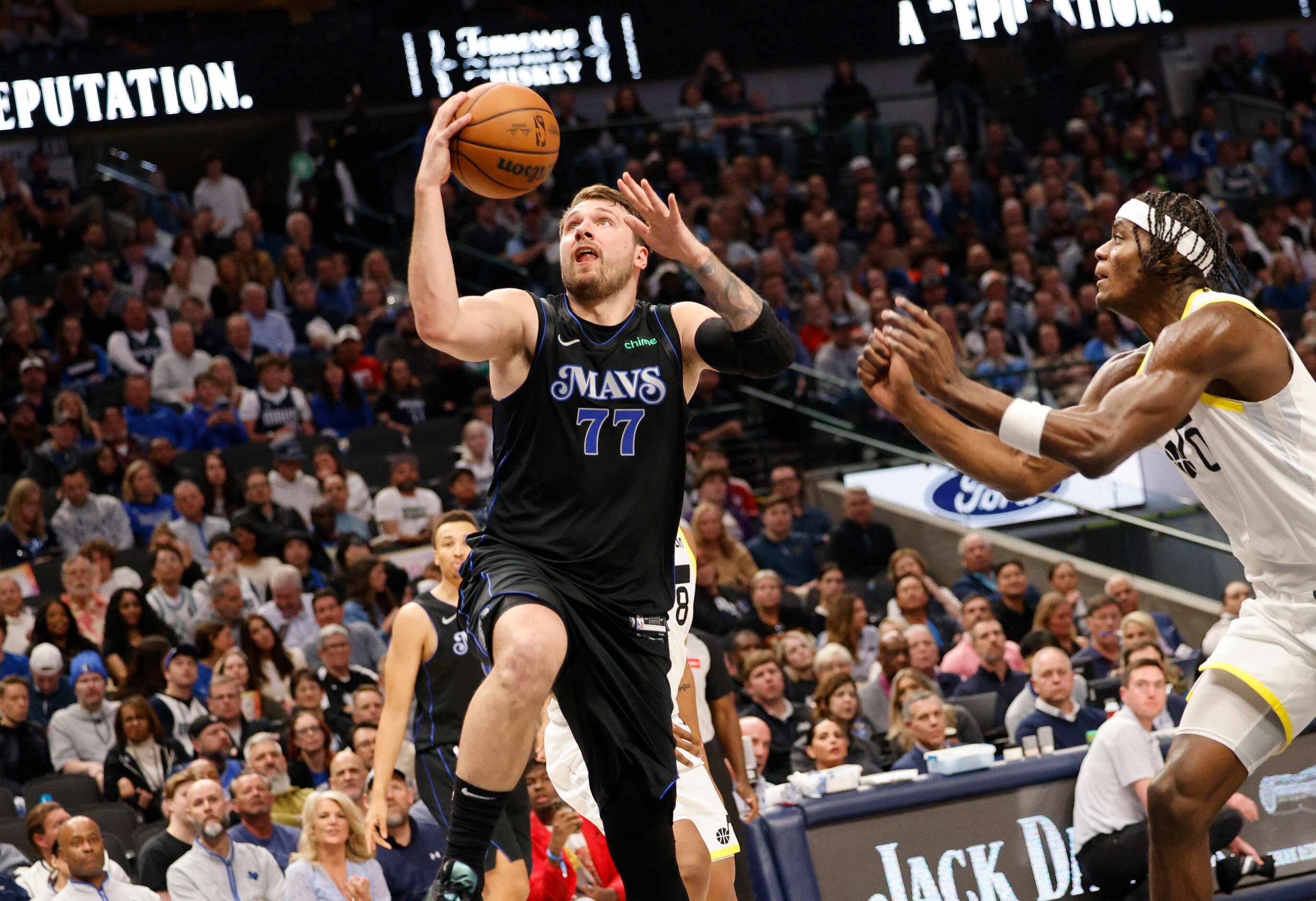 Dallas Mavericks guard Luka Doncic (77) attempts a jump shot as Utah Jazz forward Taylor...