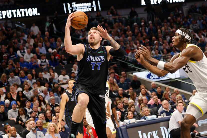 Dallas Mavericks guard Luka Doncic (77) attempts a jump shot as Utah Jazz forward Taylor...