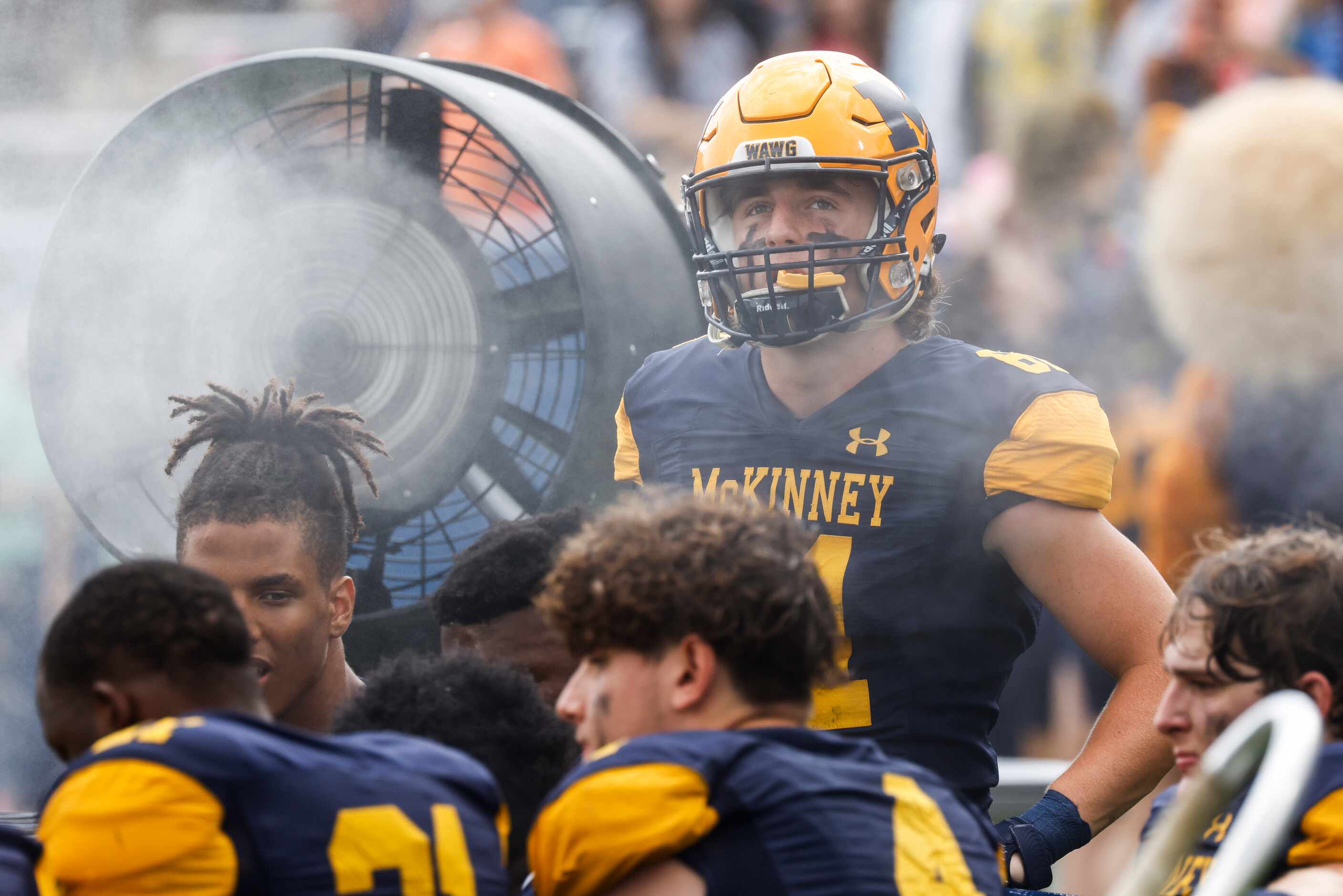 McKinney High players cool off during the second half of a season-opening football game...