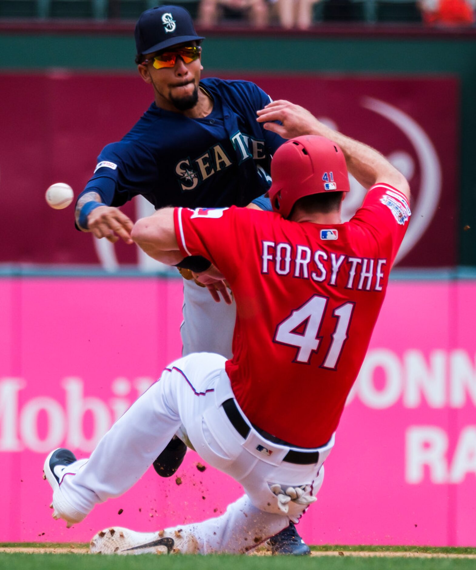 Seattle Mariners shortstop J.P. Crawford makes the relay over Texas Rangers shortstop Logan...