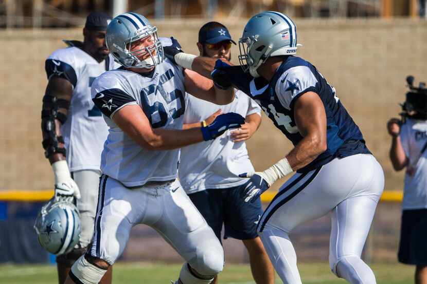 FILE - Cowboys offensive tackle Mitch Hyatt (65) takes on defensive end Jalen Jelks (74)...