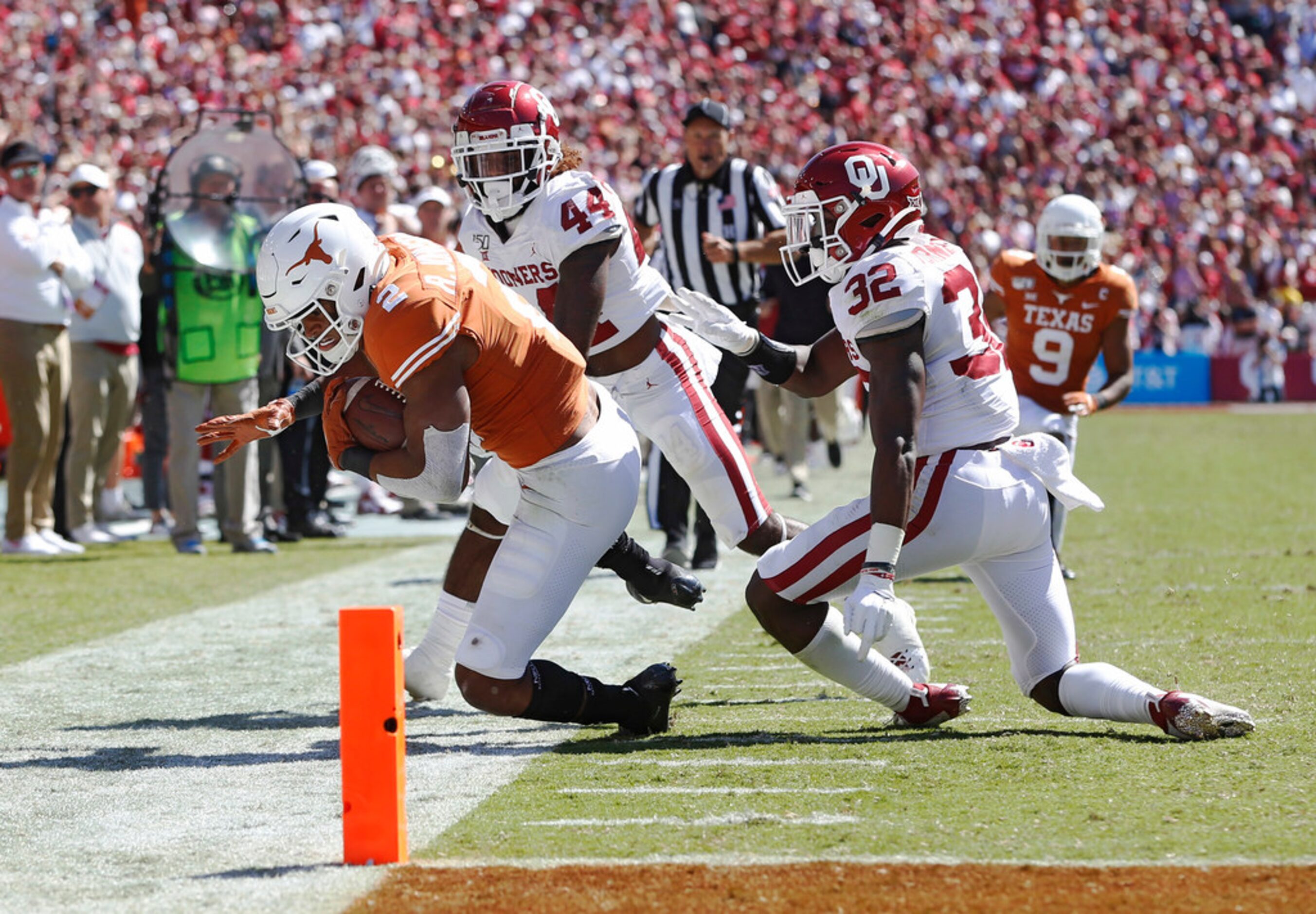 Texas Longhorns quarterback Roschon Johnson (2) is pushed out of bounds by Oklahoma Sooners...