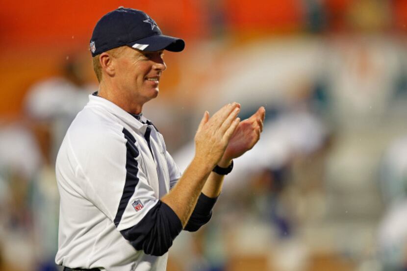 Jason Garrett greets his players during a preseason game against Miami at Sun Life Stadium...