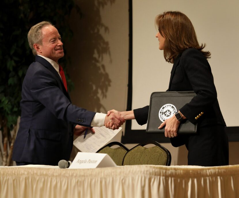 Candidates Phillip Huffines and Angela Paxton shake hands after a Republican Club...