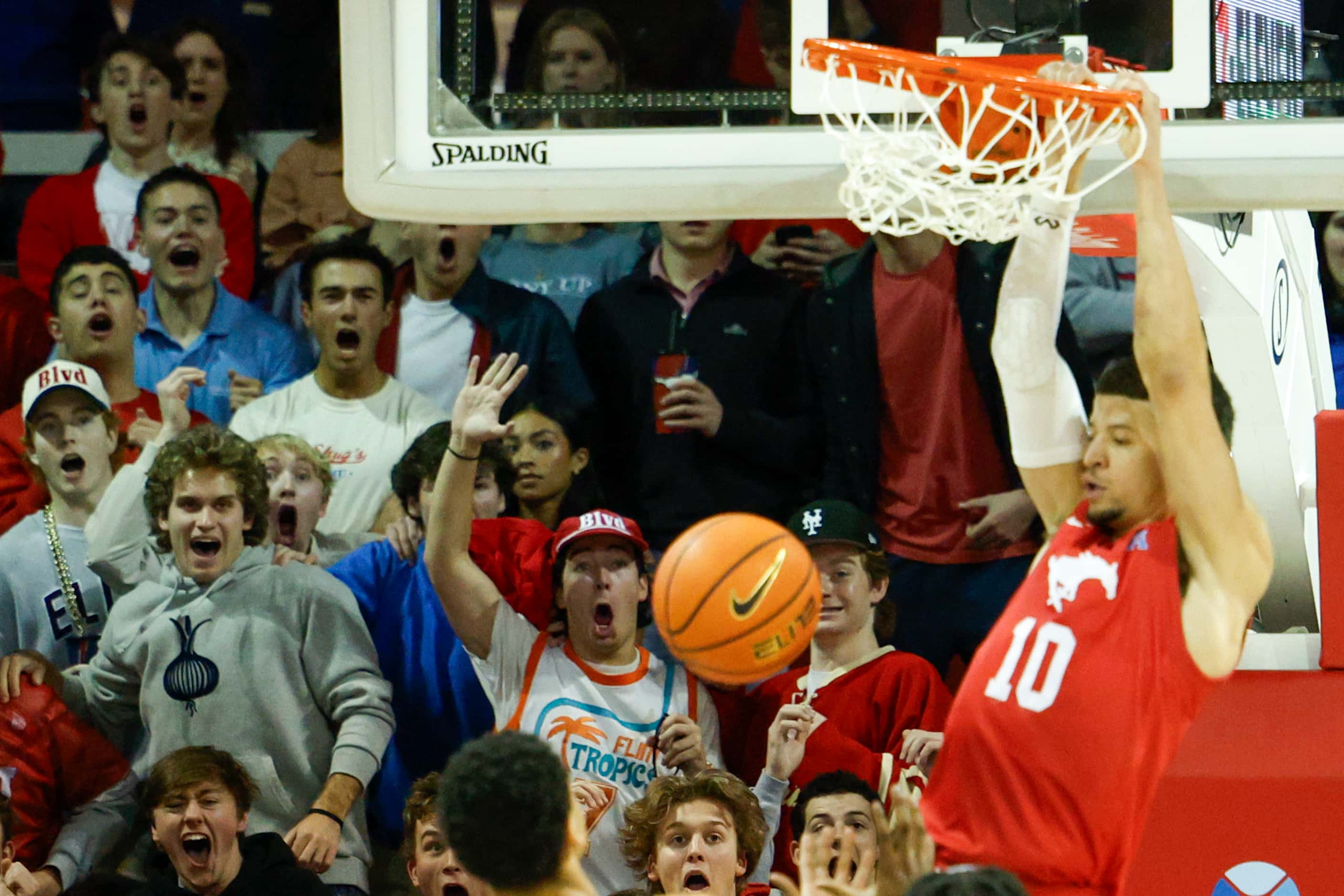 SMU students react as SMU forward Samuell Williamson (10) dunks the ball during the first...