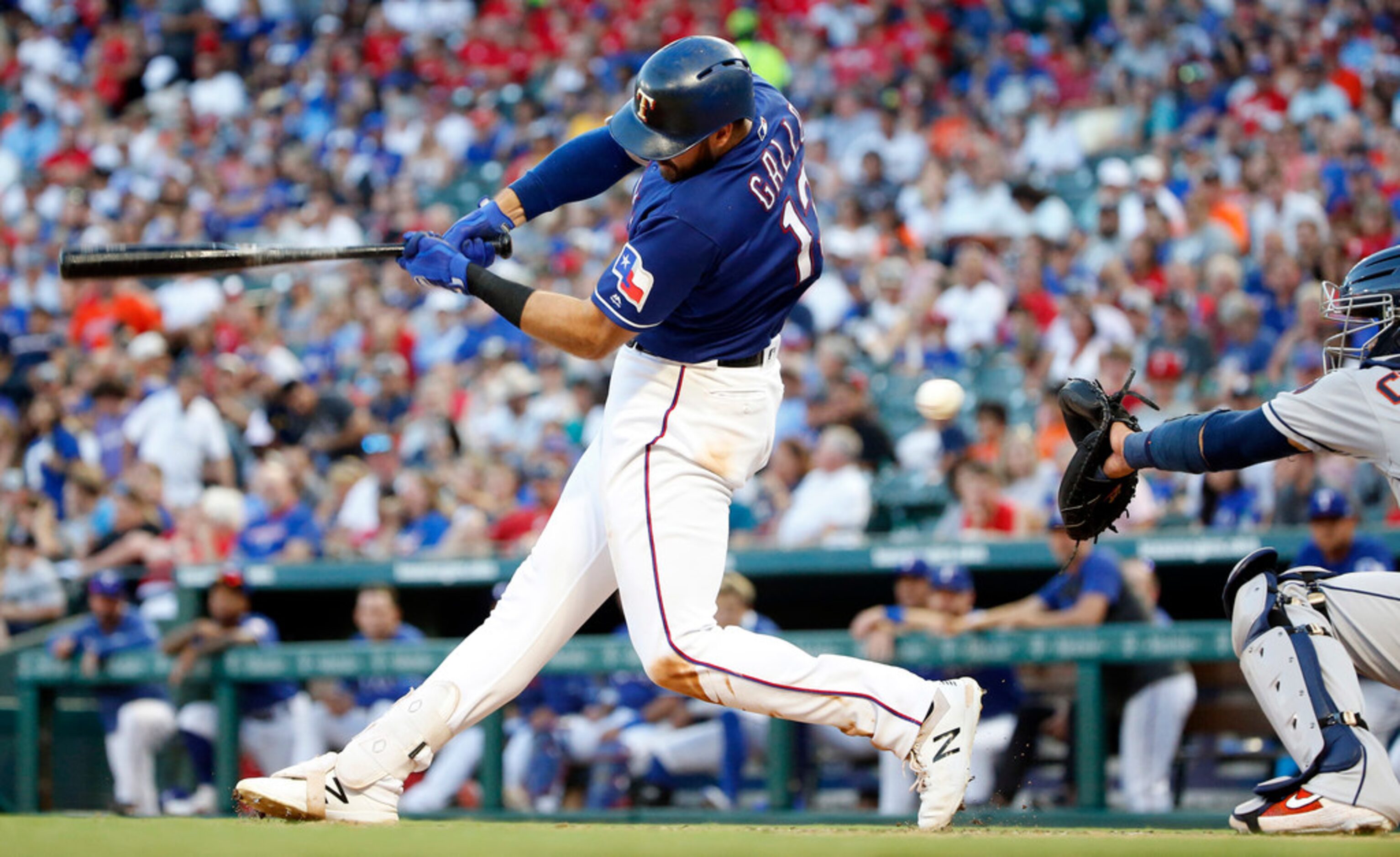 Texas Rangers batter Joey Gallo (13) swings and misses on a Houston Astros pitch during the...