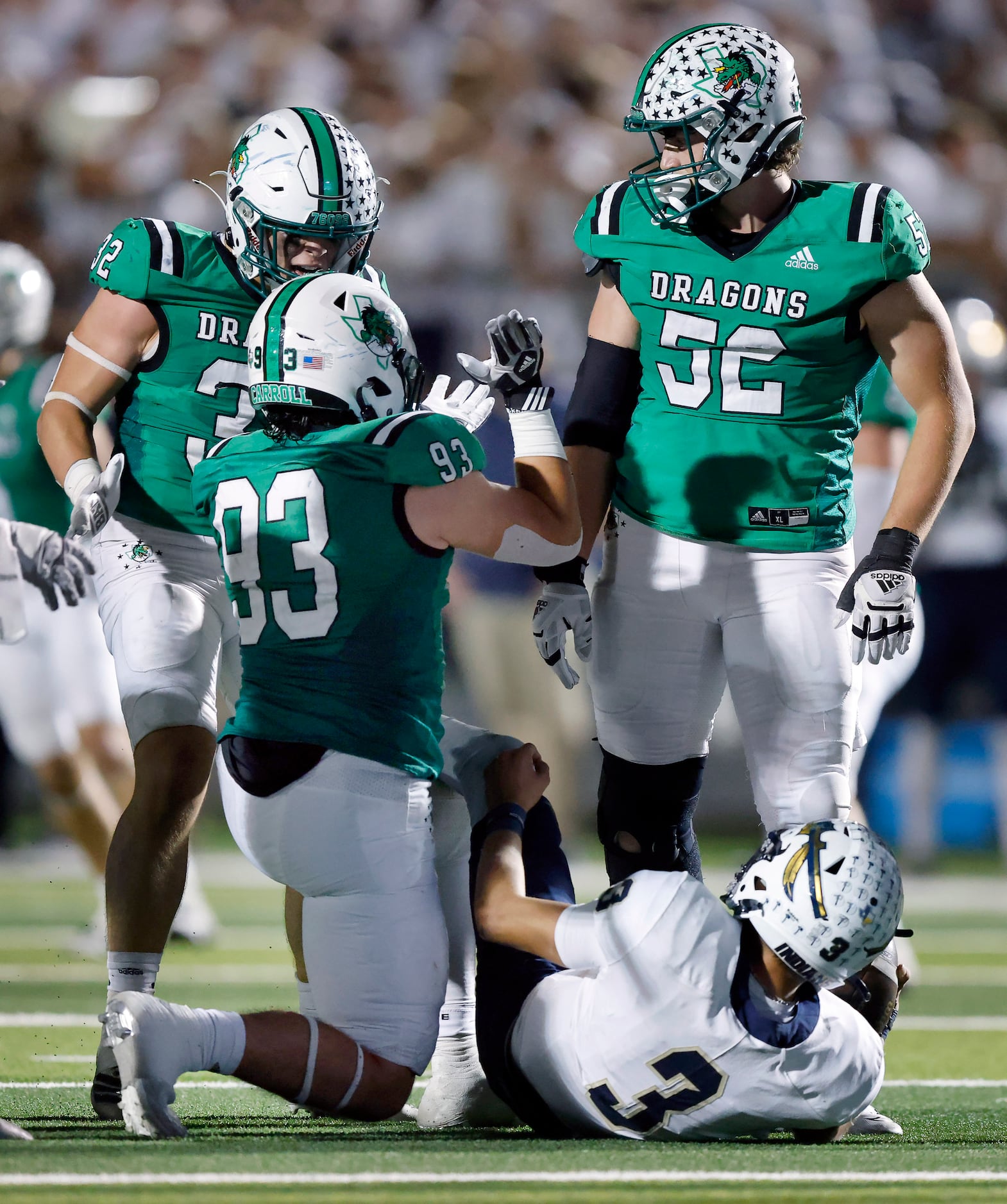 Southlake Carroll lineman Zach Scarborough (93) is congratulated on his fourth quarter sack...