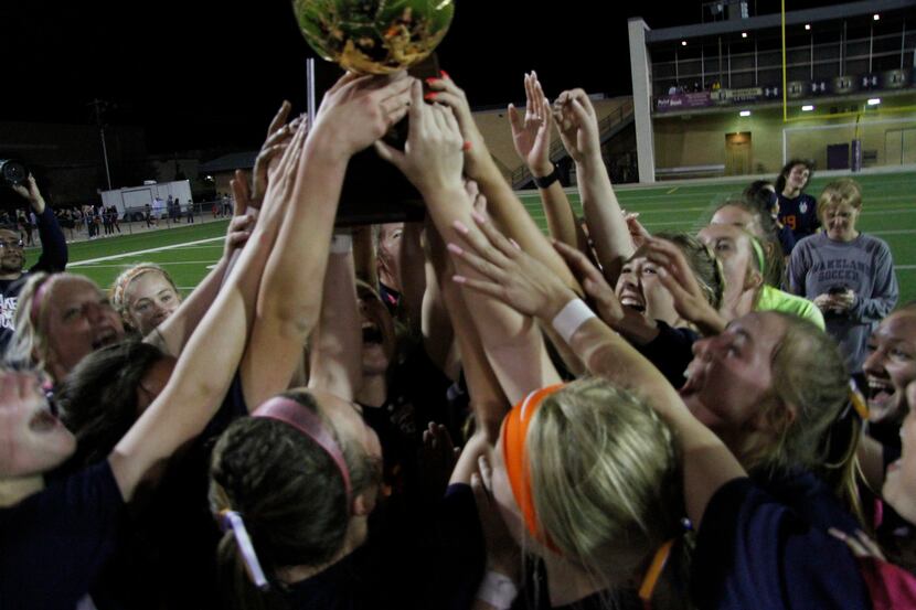 Frisco Wakeland players hoist the state semifinal trophy after beating Grapevine 3-2 in a...