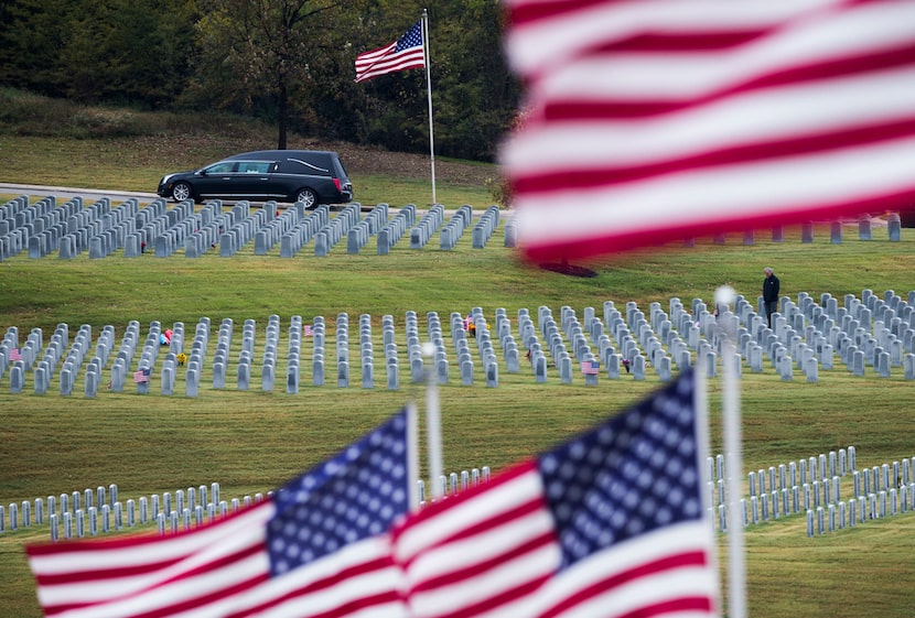 A hearse containing the remains of Army Corporal Albert "Buddy" Mills arrives at Dallas-Fort...