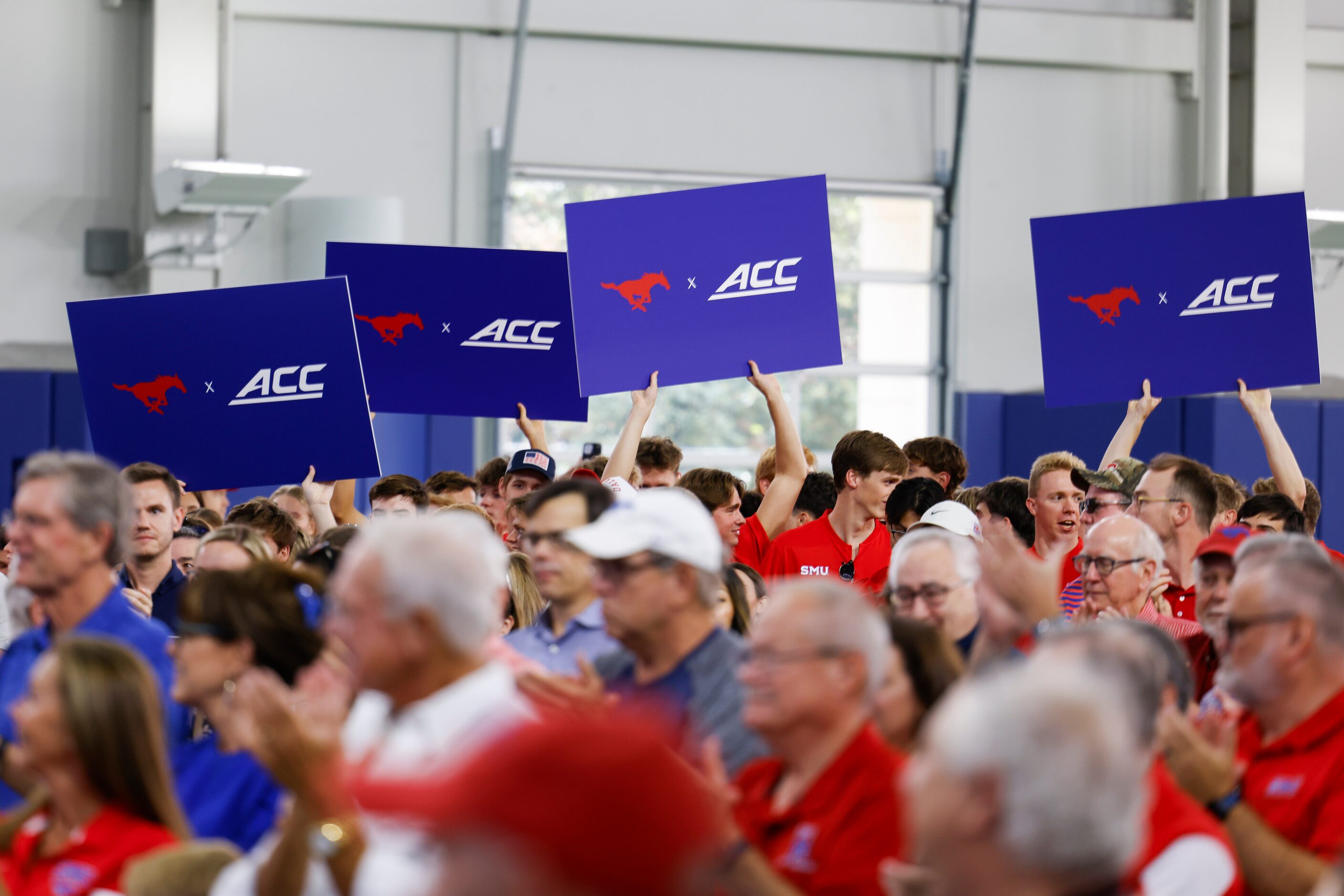 Attending crowd cheer upon the announcement of SMU’s move to NCAA Atlantic Coast Conference...