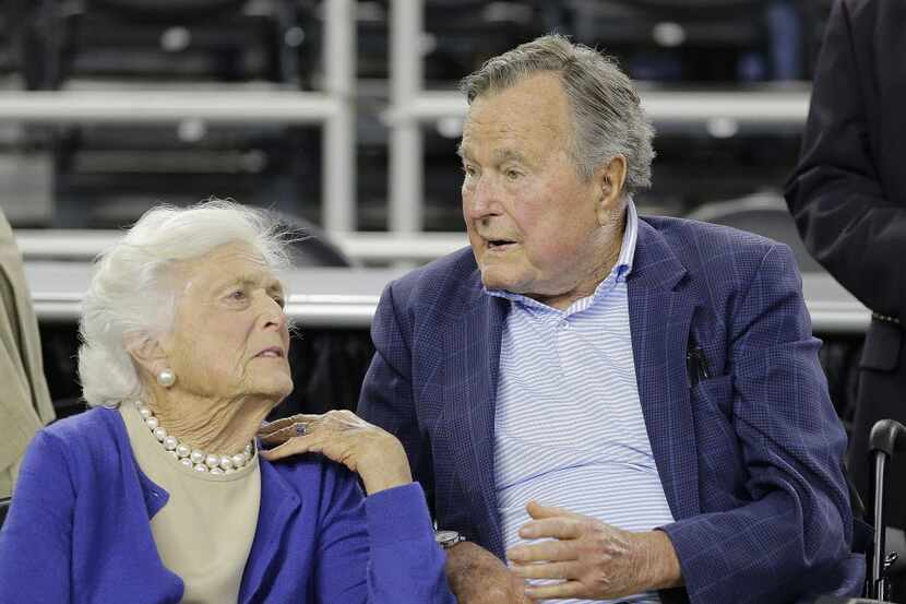 Former President George H.W. Bush and his wife, Barbara Bush, speak before a college...