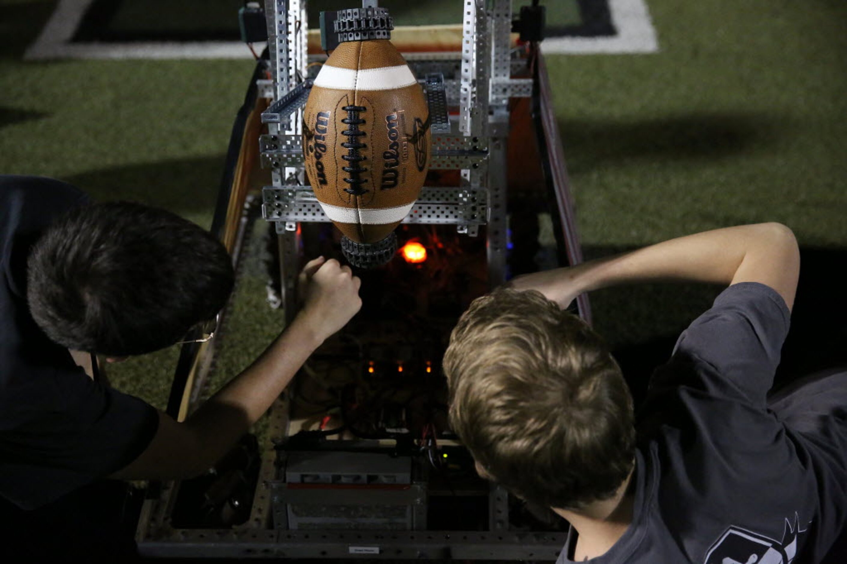 Jacob Jeter (left), 16, and Joey Moon, of the Waxahachie Robotics team, work on Dead Mouse,...