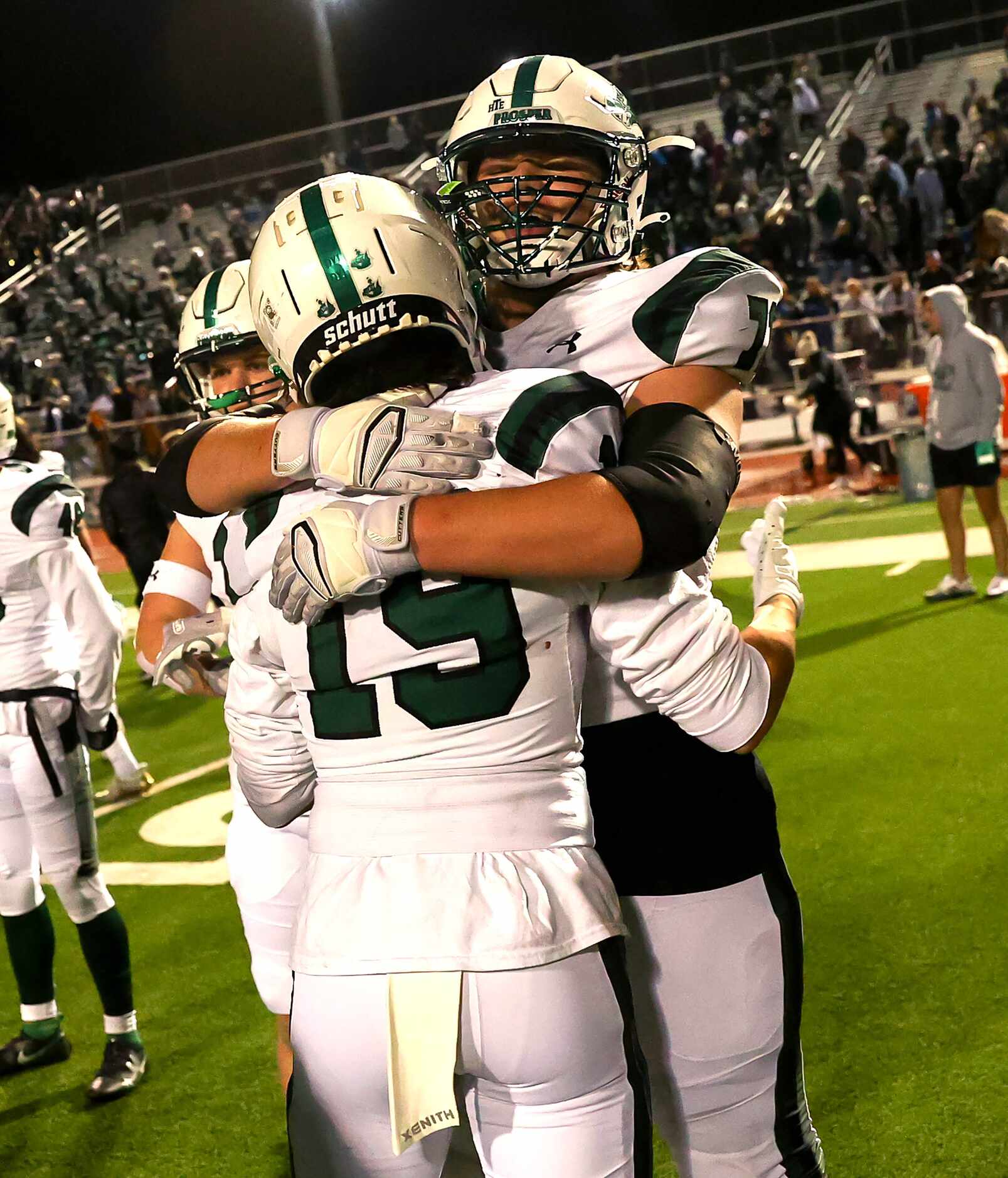 Prosper's Lance Utley (19) and Colin Beesley (71) hug each other after beating Flower Mound...