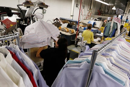 Candy Rodriguez (left) and Maria Mendoza press shirts at Sunshine Laundry and  Dry Cleaners...