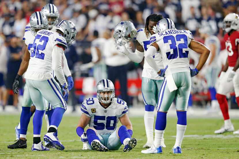 Dallas Cowboys middle linebacker Sean Lee (50) sits on the field appearing to have injured...