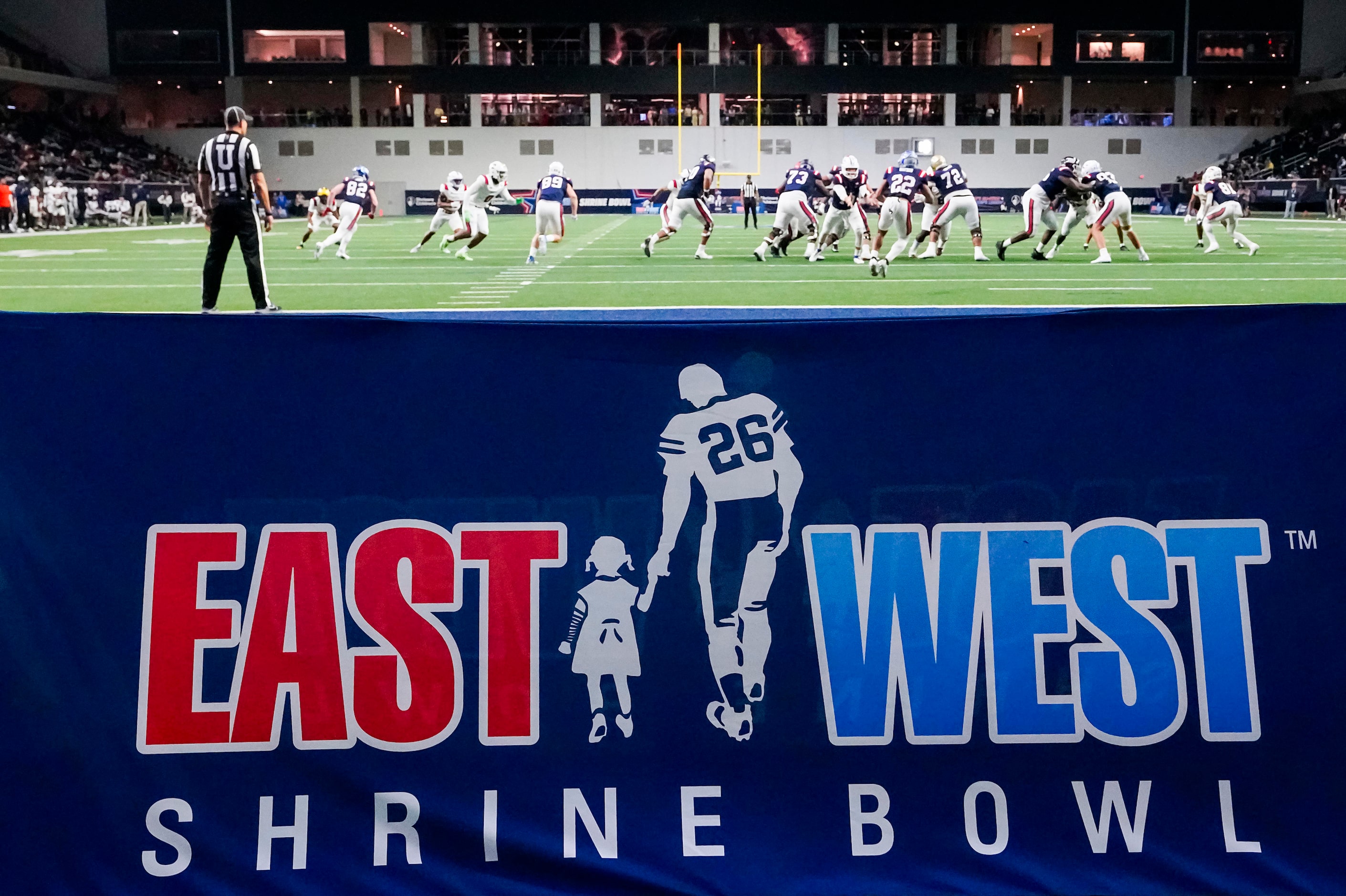 West quarterback  Kedon Slovis of BYU  (10)  tosses the ball to running back Blake Watson of...