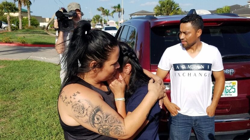 Reina, 40, of El Salvador, with family friend Carlo Mauricio Rodriguez, hugs her 17-year-old...