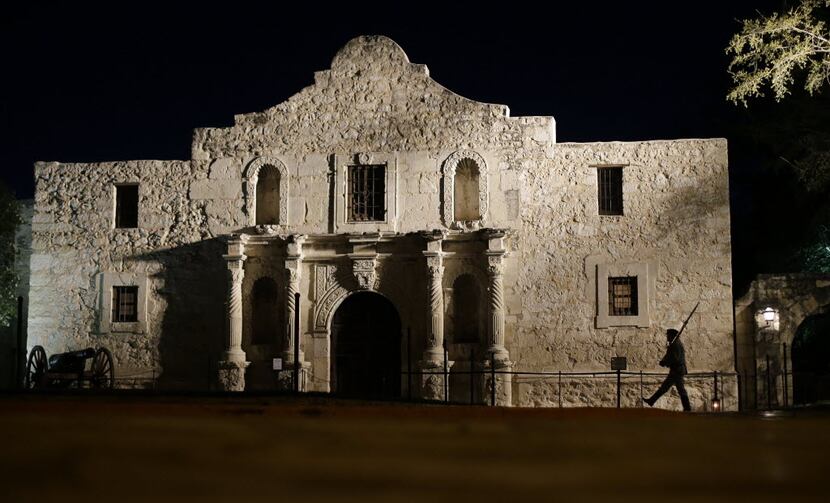 John Potter, a member of the San Antonio Living History Association, patrols the Alamo in...