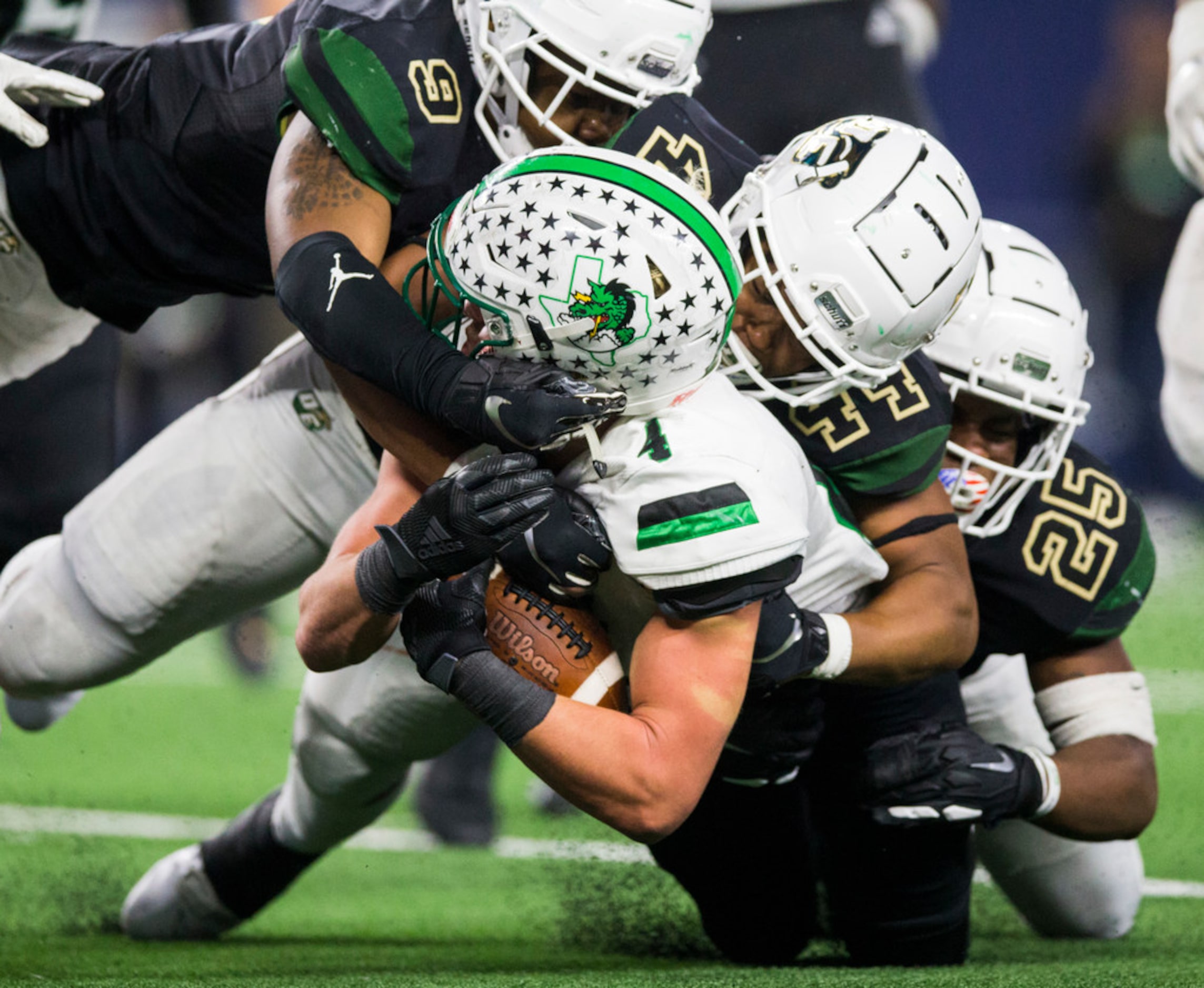 Southlake Carroll running back Owen Allen (4) is tackled by DeSoto linebacker Ridarius...