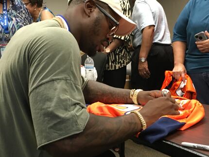 Von Miller signed a jersey for fans during a ceremony Friday at DeSoto police headquarters.