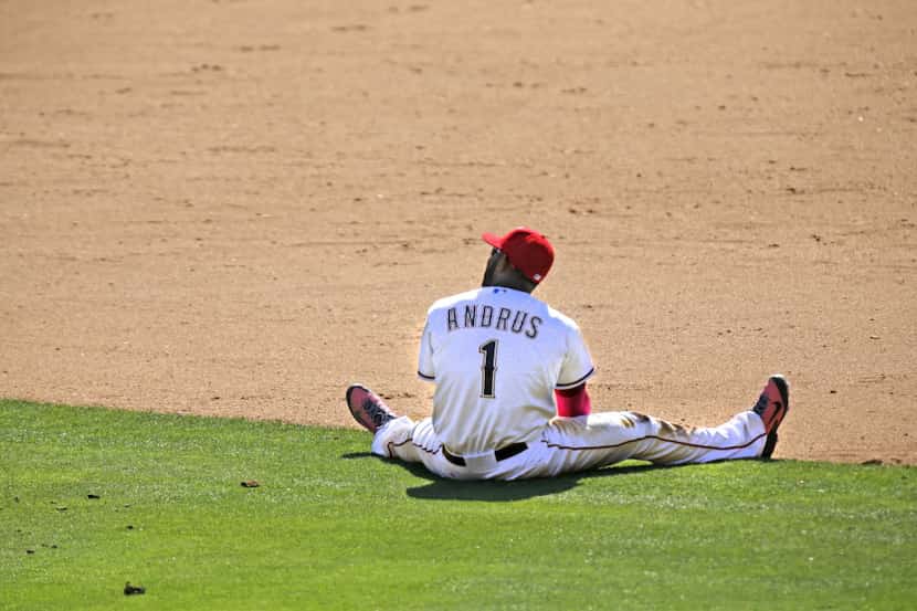 Texas shortstop Elvis Andrus sits on the turf after failing to come up with Xander Bogaerts'...