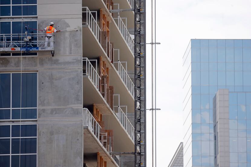 Construction continues at The Victor, an apartment tower next to American Airlines Center in...