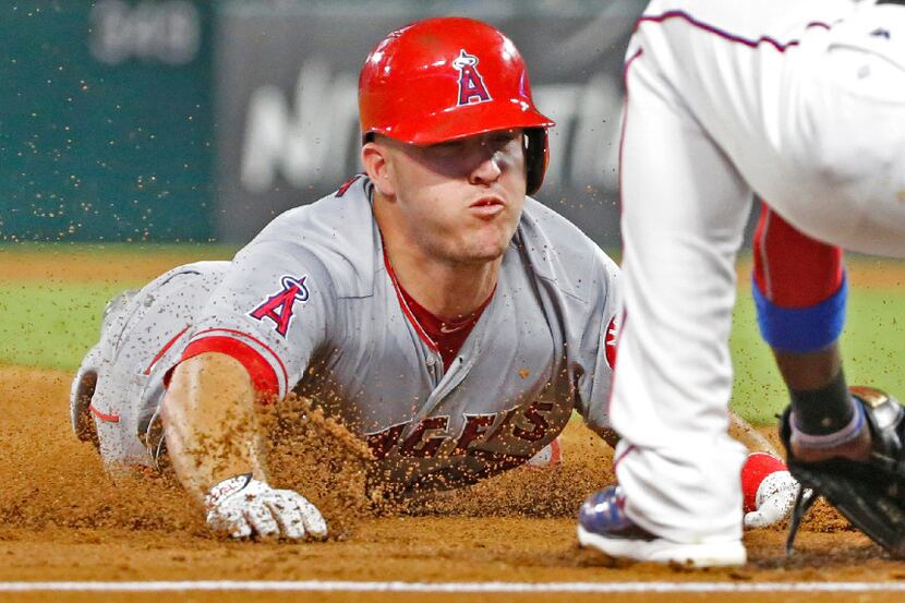 Los Angeles Angels center fielder Mike Trout (27) is out trying to steal third base in the...