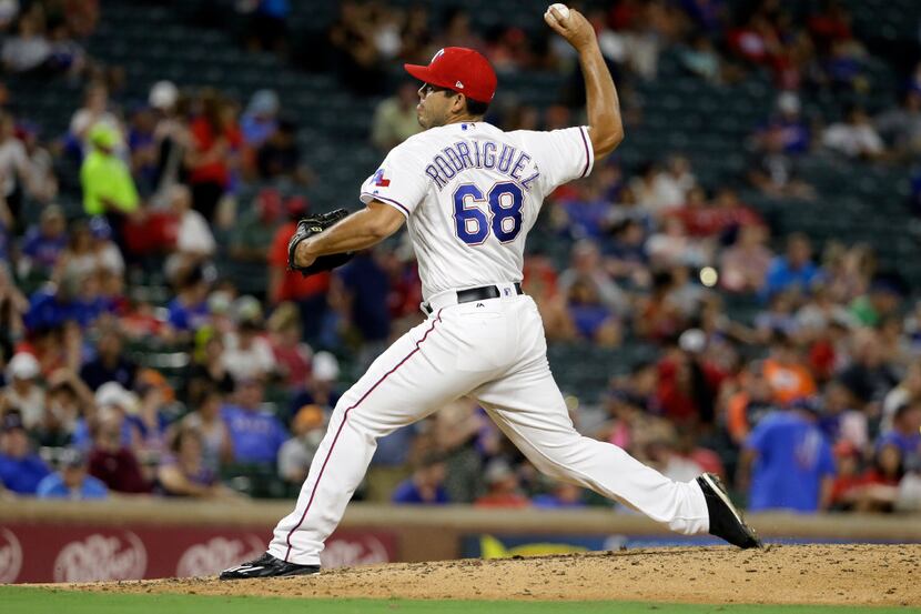 Texas Rangers relief pitcher Ricky Rodriguez (68) throws to the Detroit Tigers in the...