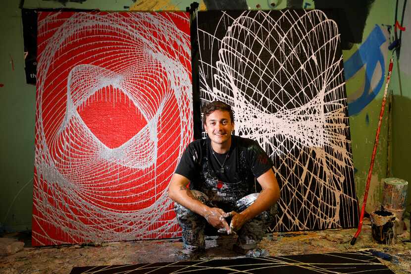 Action painter Cole Newman poses for a photo with his pendulum paintings at his studio in...